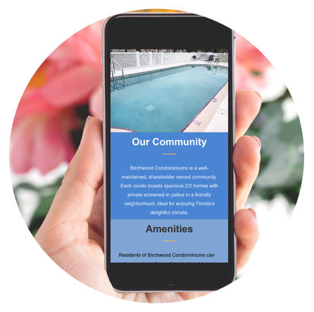 A hand holds a cell phone showing a website built to be compliant to Florida rules for condo associations